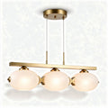 Three-light modern pendant lamp with frosted glass globes and brass finish