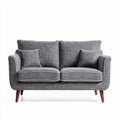 Two-seater sofa in gray fabric with decorative cushions and wooden legs